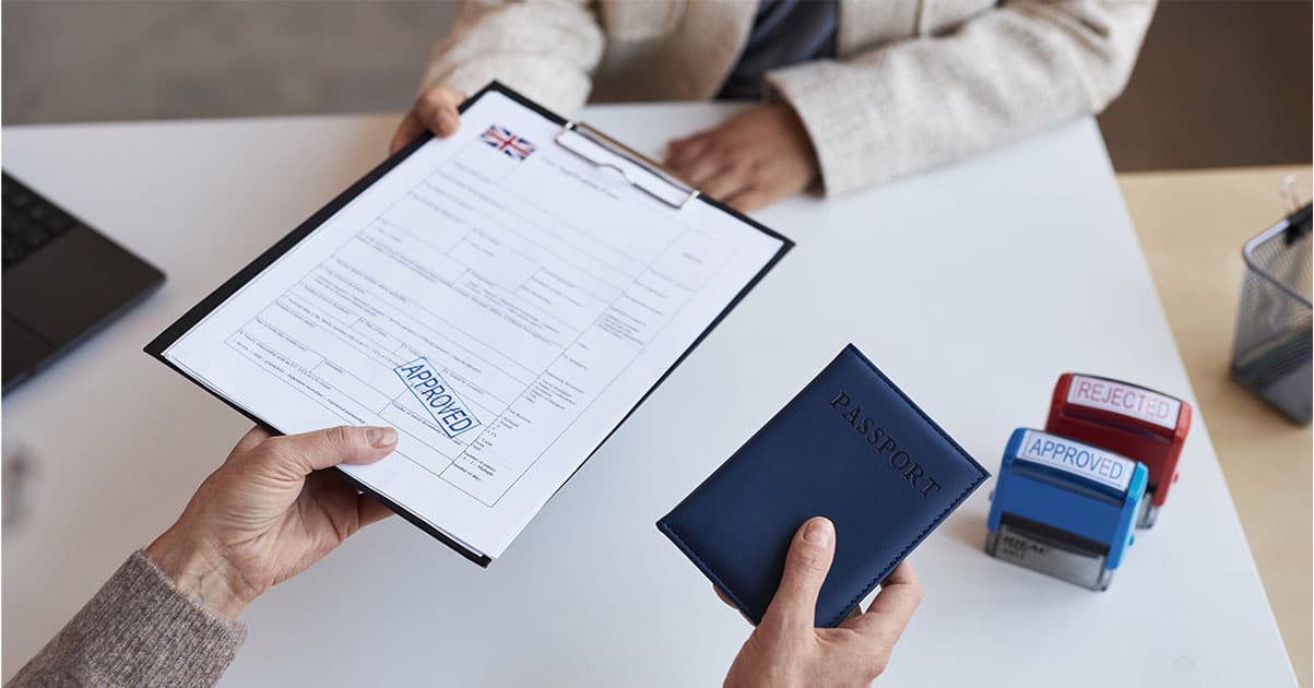 Passport with visa stamps alongside flight documents